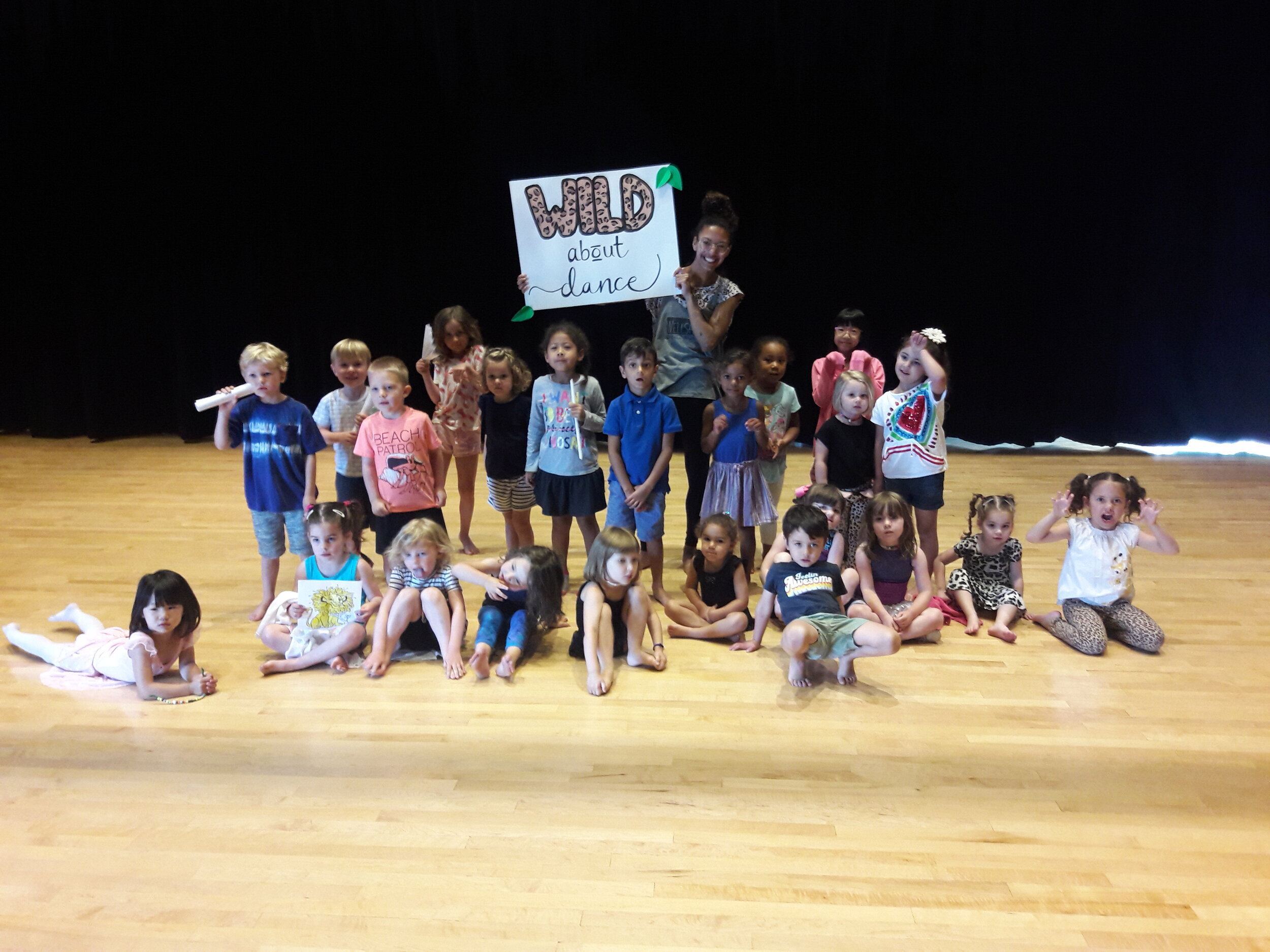 Group photo with students with sign "Wild about Dance"