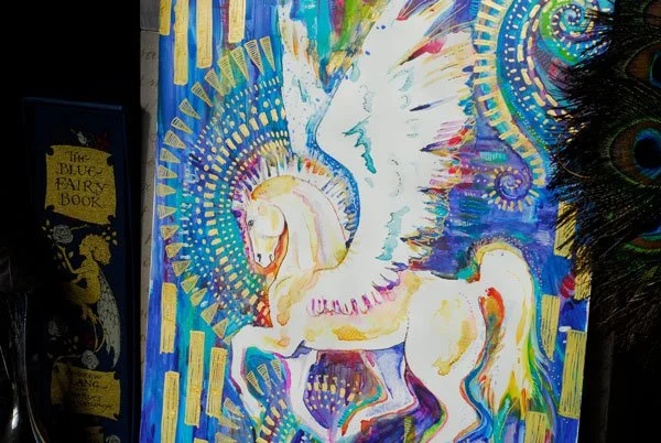 Painting of a white Pegasus surrounded by vibrant colours.