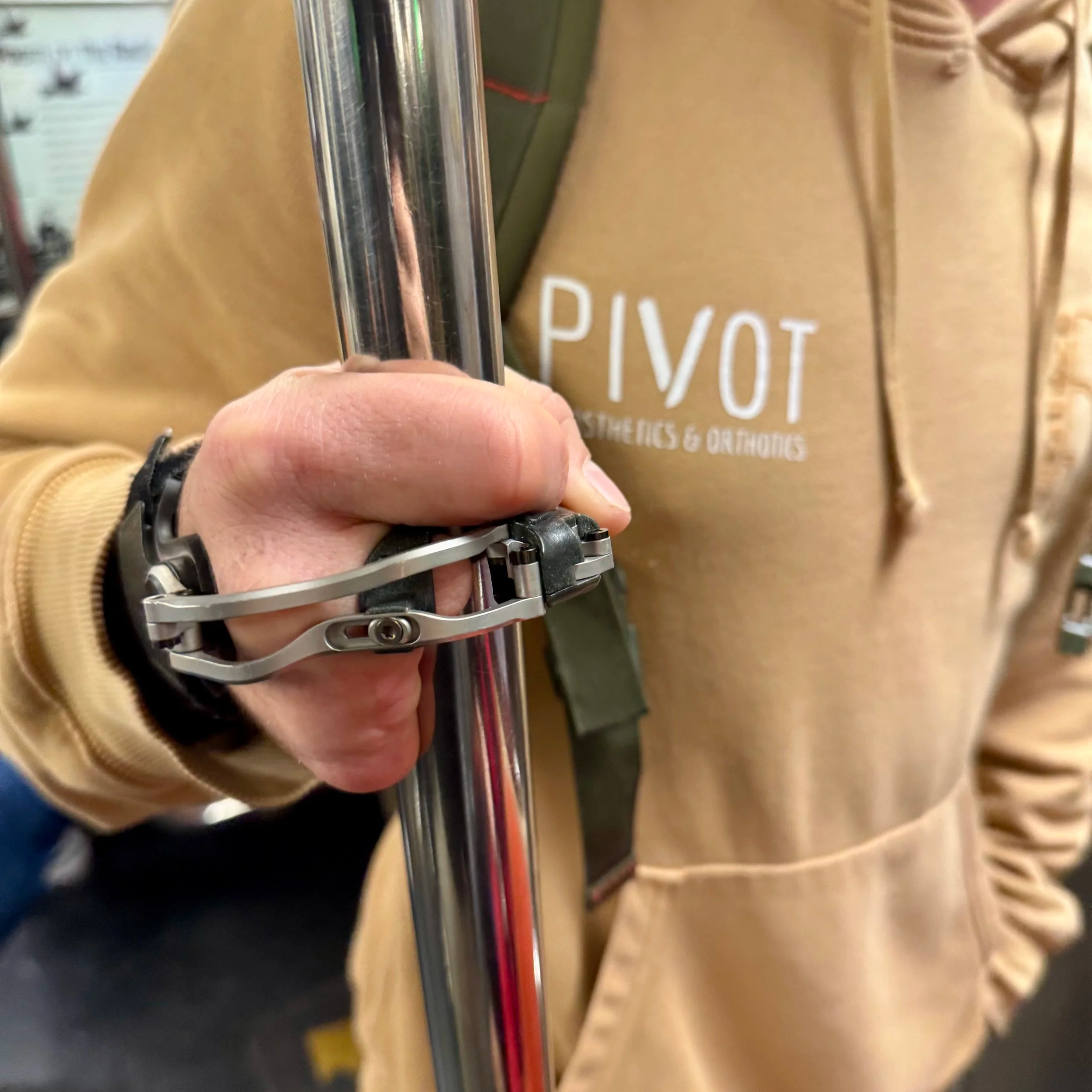 Partial hand prosthesis shown gripping a pole on the train