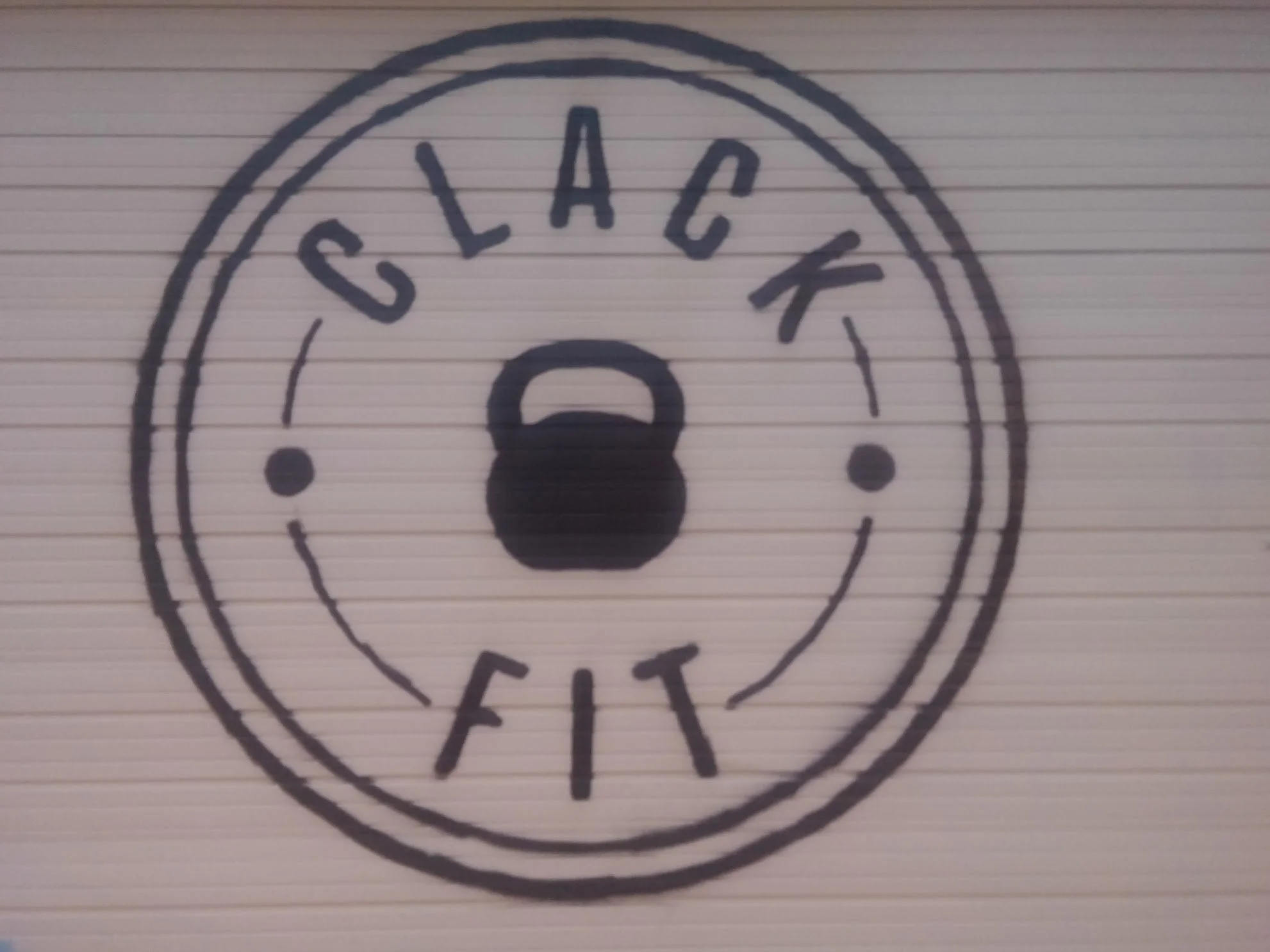 The ClackFit logo: a circle with a kettlebell in the center.