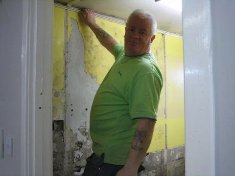 Ramie plastering the holes in the wall