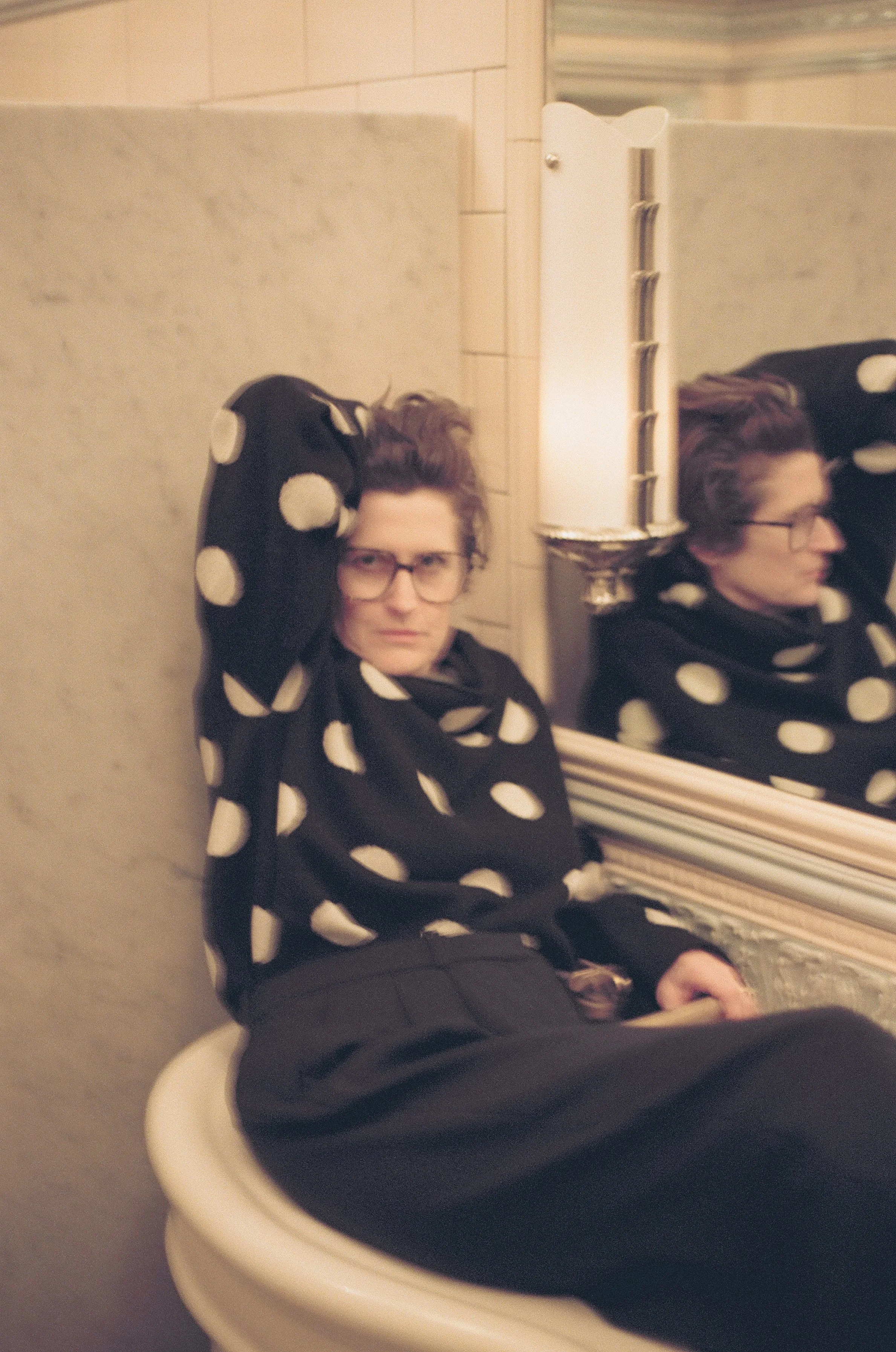 Alex Auder in the sink at the Chelsea Hotel, 2024