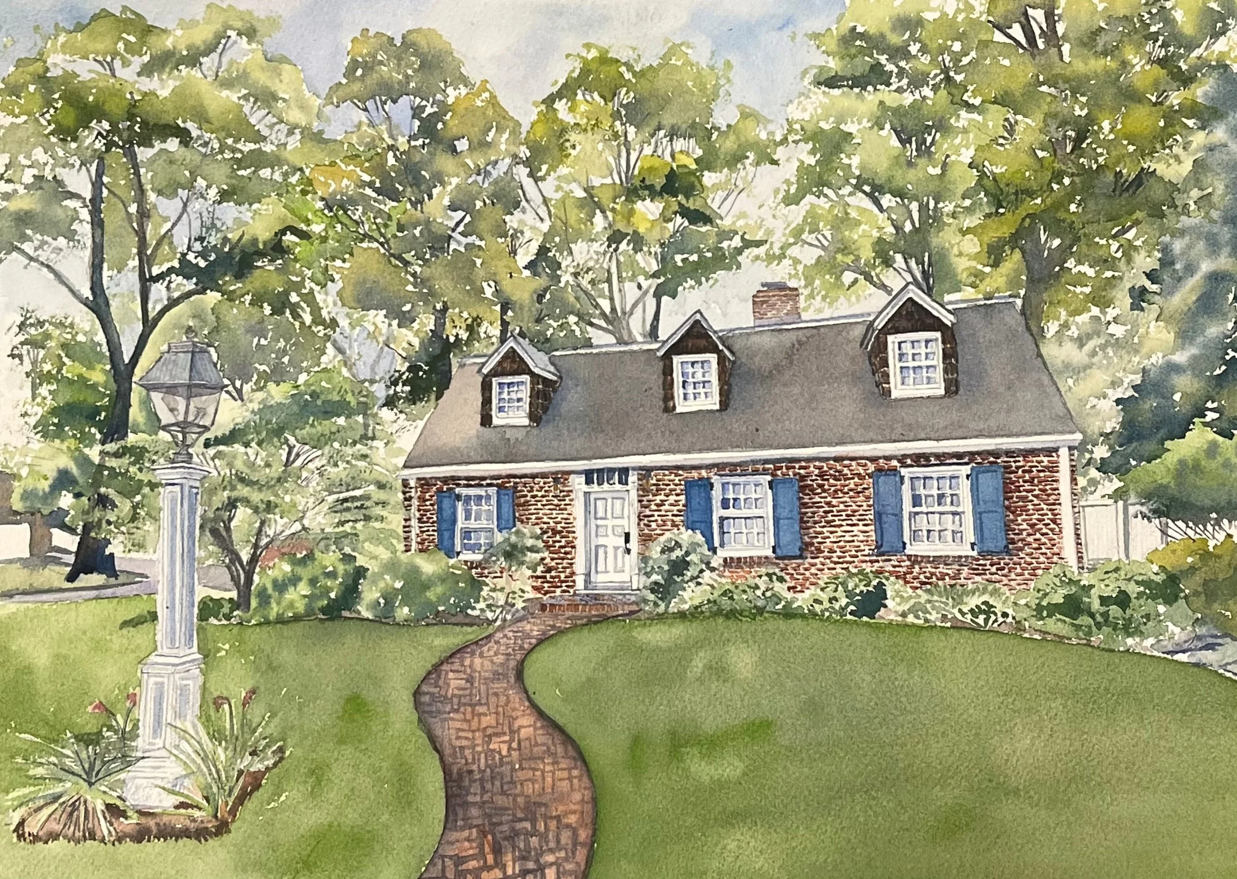 Watercolor painting of a brick house with blue shutters, a curved brick walkway leading to the front door, surrounded by greenery and mature trees, with a vintage streetlamp on the left.
