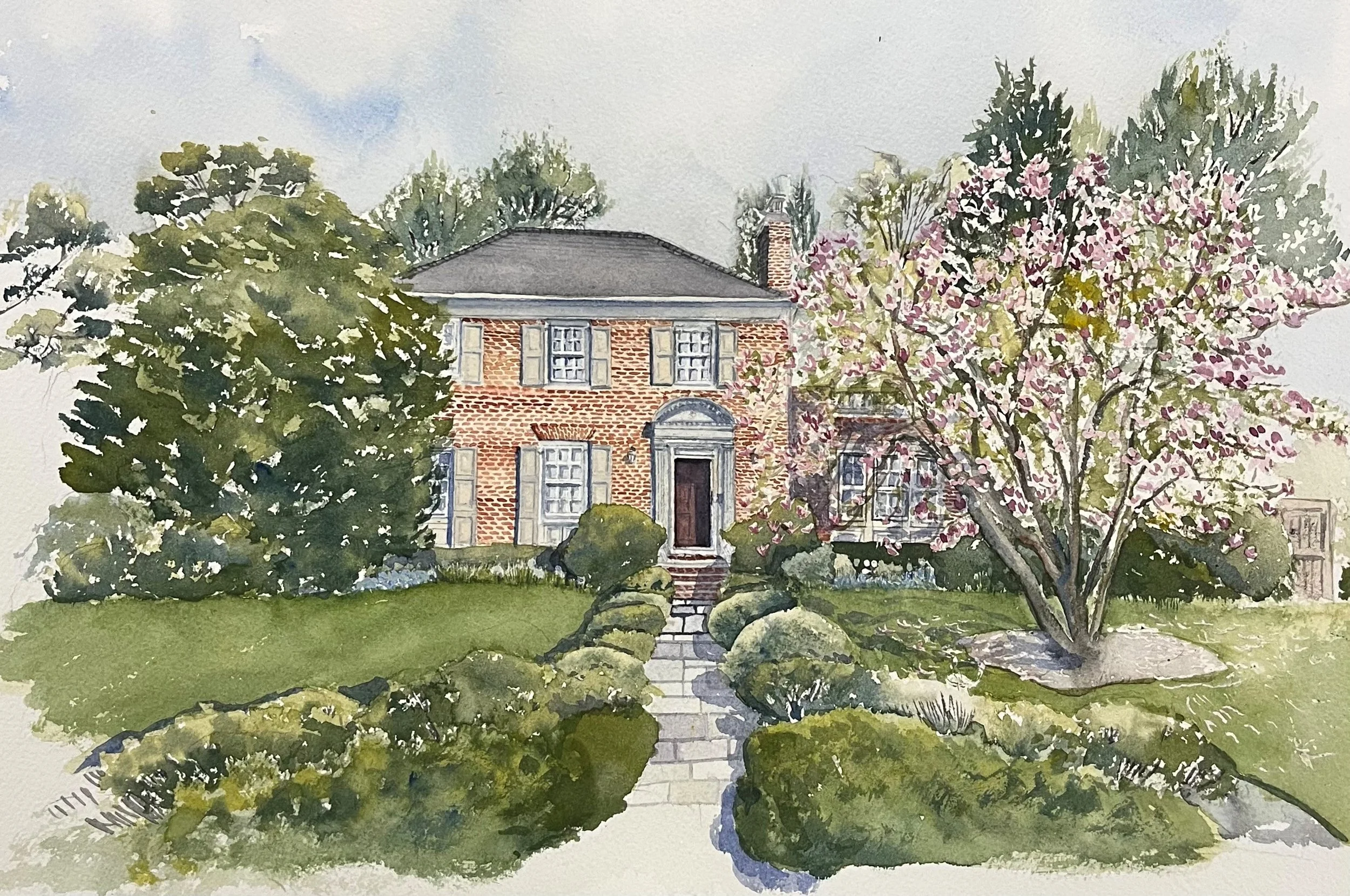 Watercolor painting of a brick house with gray shutters, surrounded by lush green trees and a flowering pink tree in the front yard, with a stone pathway leading to the front door.