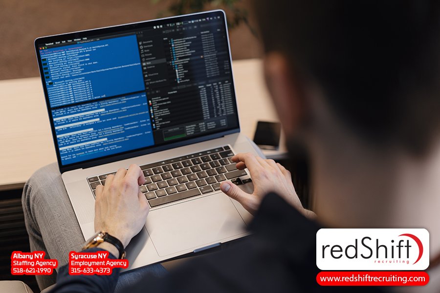 Close-up of a developer coding grid systems on his laptop