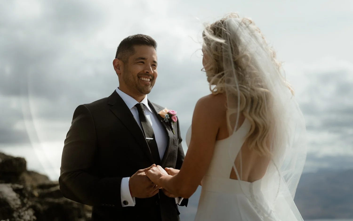 artistic wedding photographer in Queenstown, groom smiling at bride during heli wedding