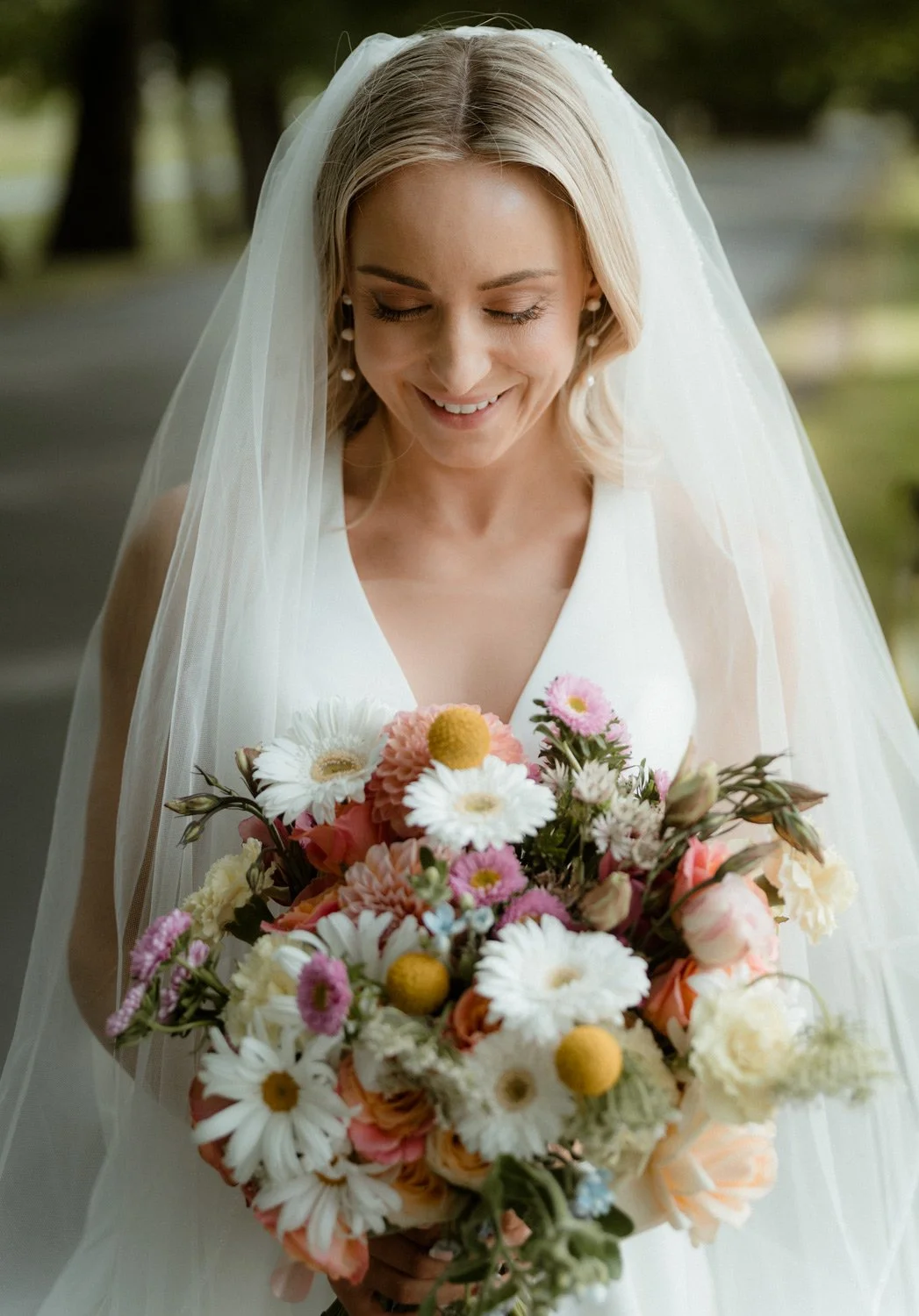 bride looking at queenstown wedding bouquet at millbrook resort