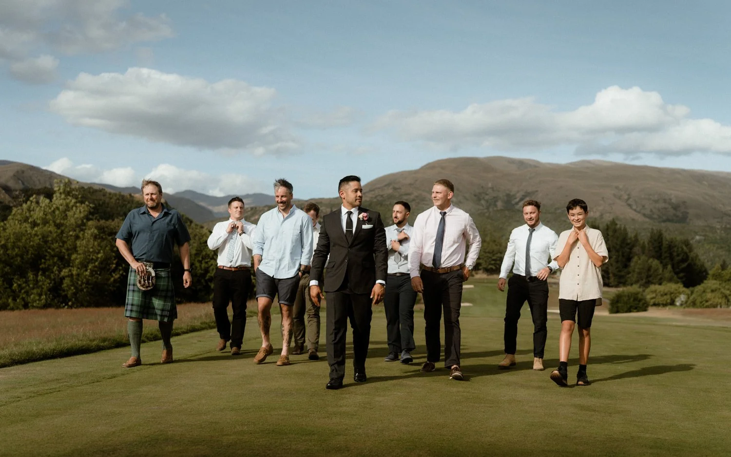 Groomsmen walking on golf course at Millbrook Resort