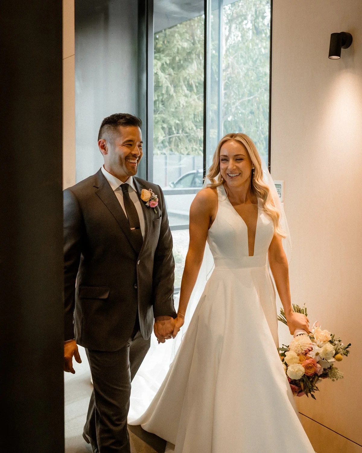 bride and groom walk into Cargo Brewery for their wedding reception