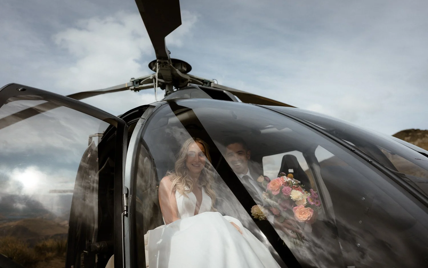 Couple sitting in epic Queenstown heli