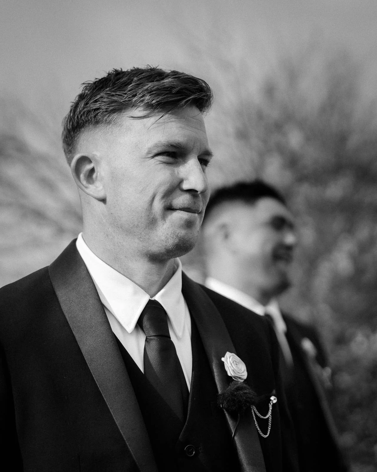 groom-smiling-bride-walks-up-isle.jpg