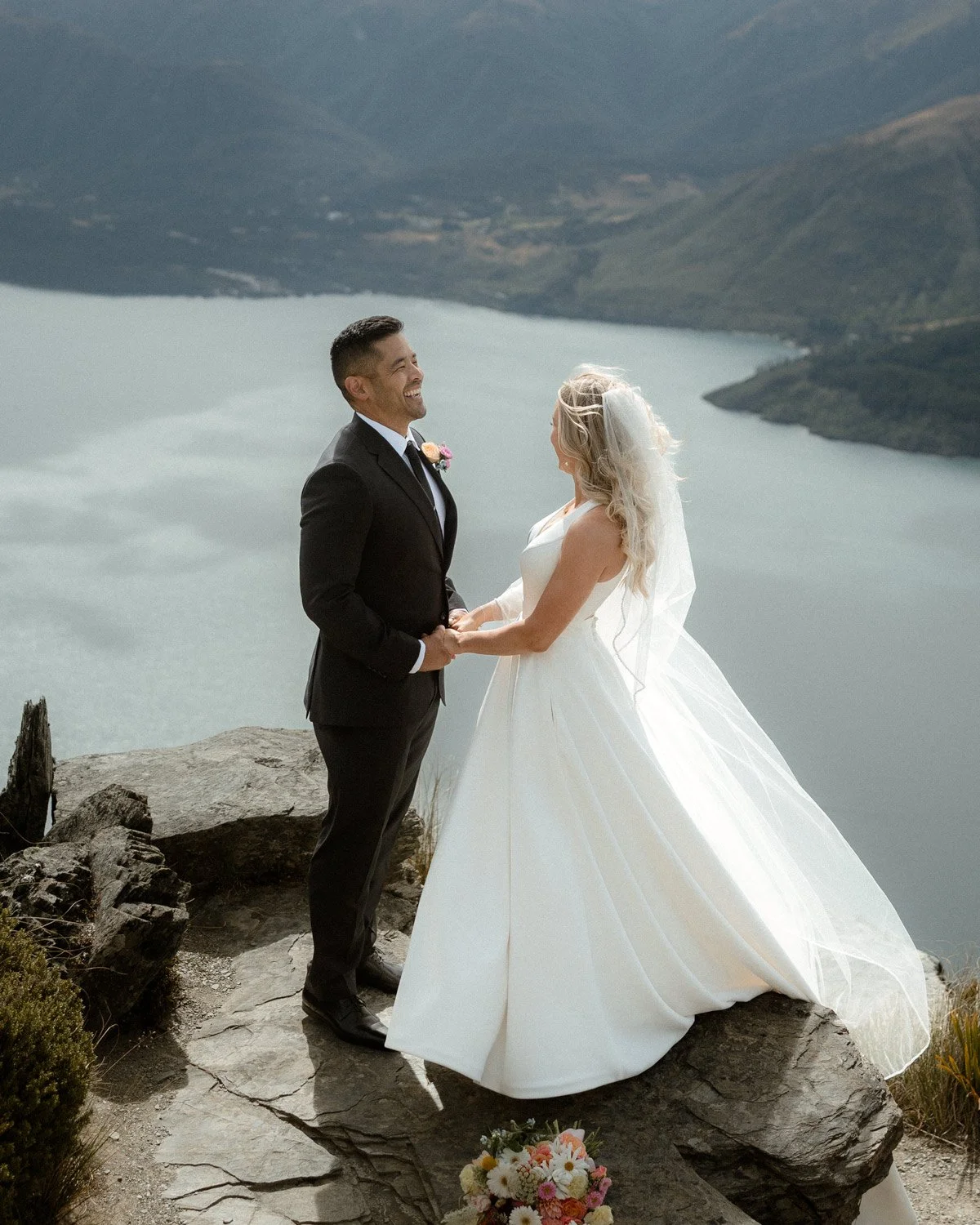 groom laughing with bride at candid heli wedding, photographer Ricky B Good photography