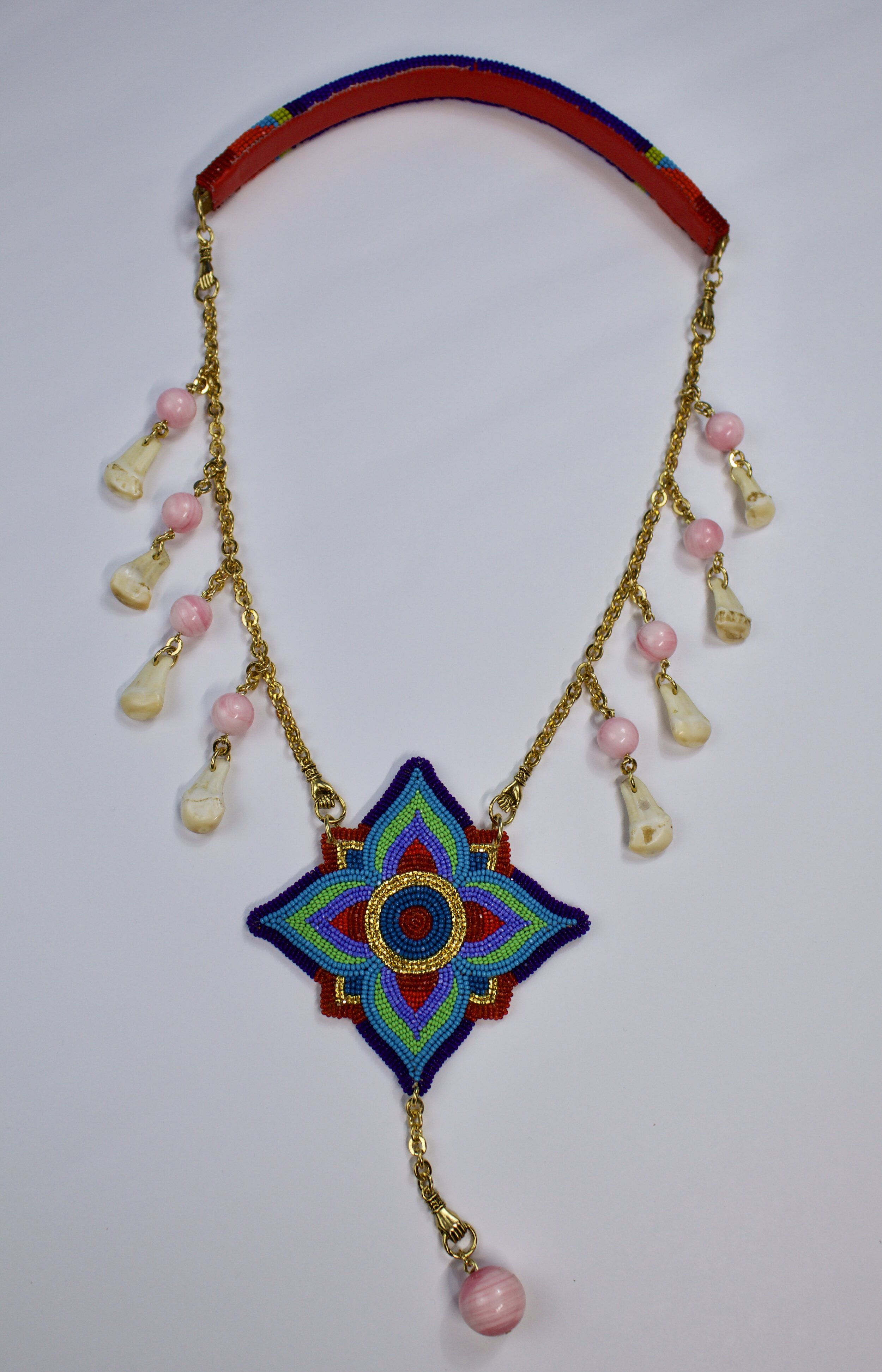 2021 December drop
beaded floral motif on smoked hide glass beads elk ivory pink conch necklace.