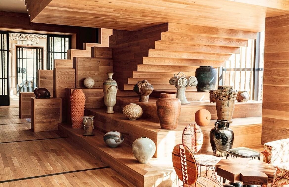 One of my favorite details at @austinproperhotel is this collection of curated pottery displayed underneath the sculptural wood staircase. @kellywearstler gets it right every time ✨