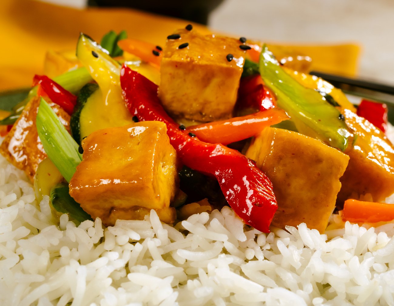 Stir-fry of tofu and vegetables served over white rice.