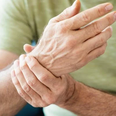 man with arthritis rubbing his wrist