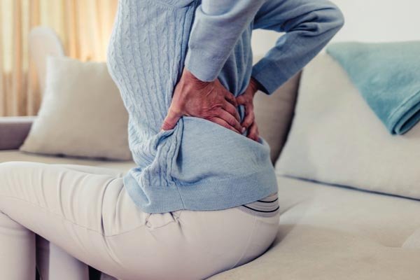 woman with pain in her back from sciatica