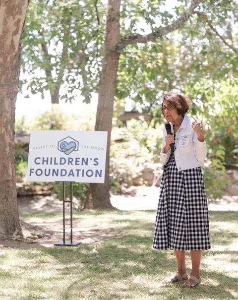 Dianne Edwards Standing in a field with a micophone