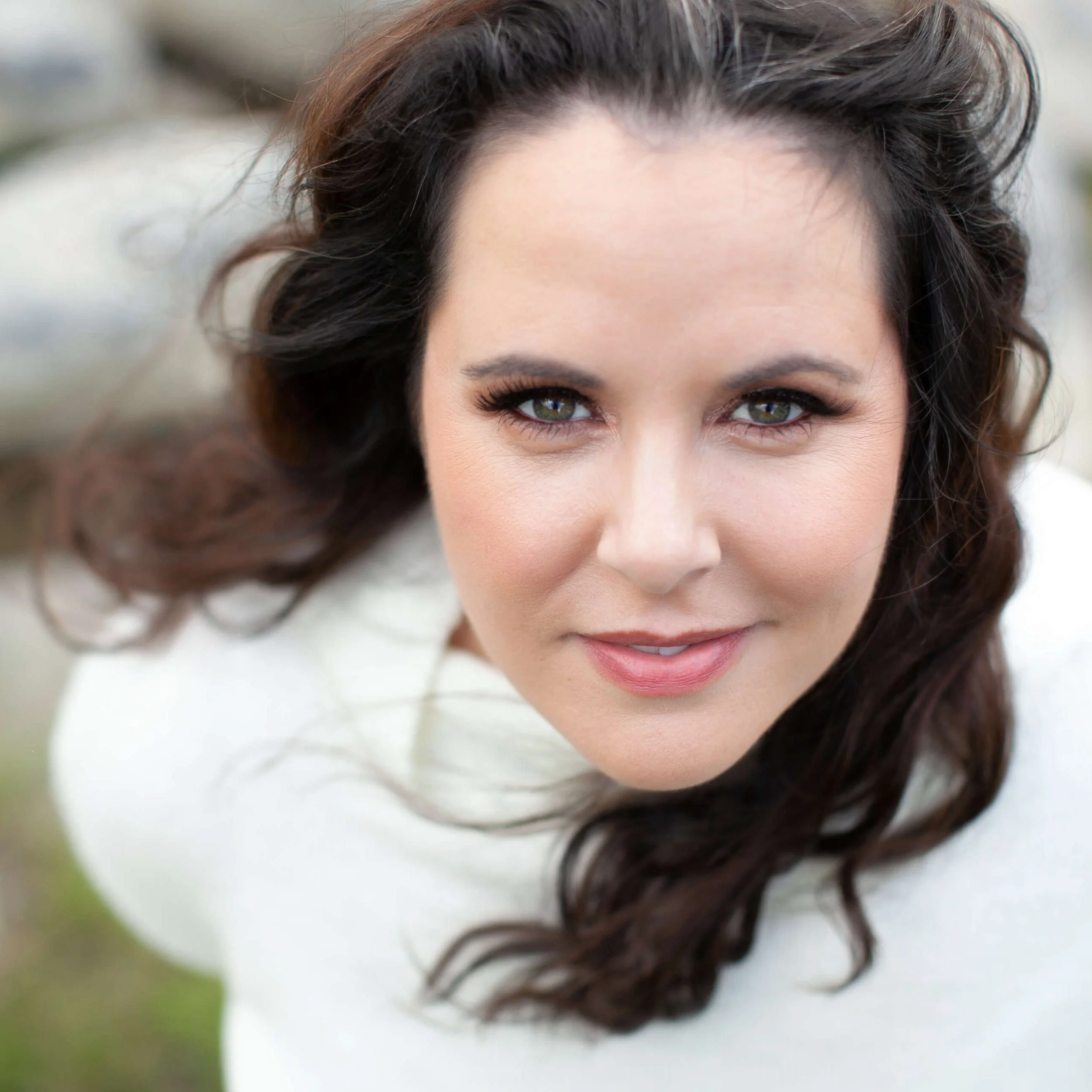 Lisa P., a coaching client of Cara Chace, smiling in a cream sweater