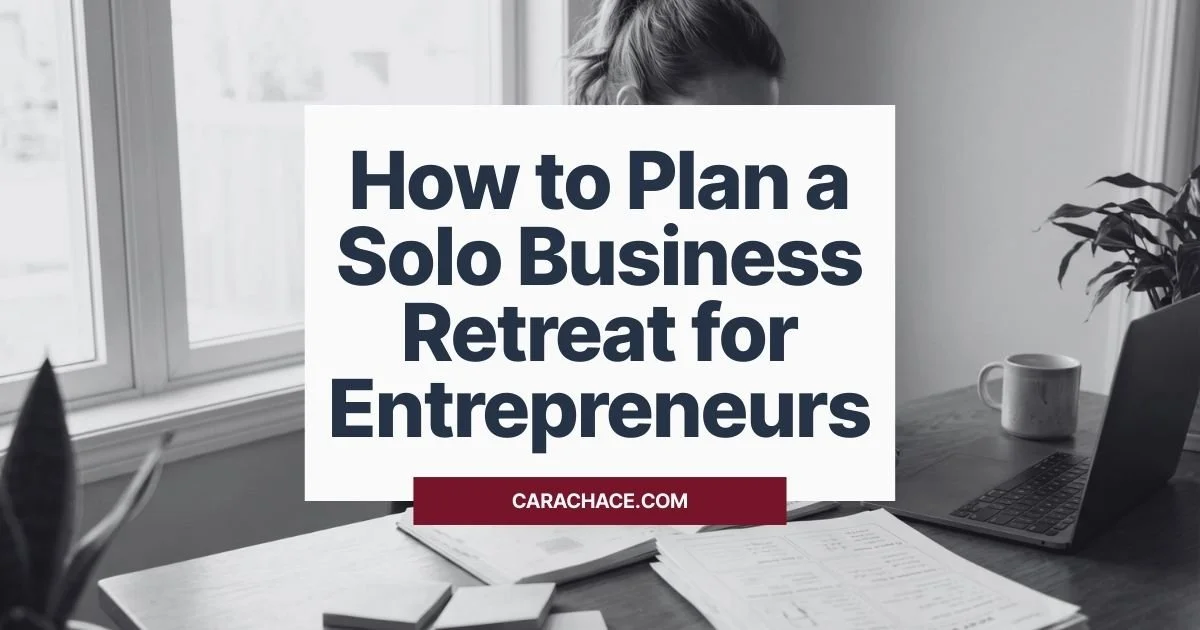 A woman entrepreneur works at a desk with papers and a laptop; overlay text: How to Plan a Solo Business Retreat for Entrepreneurs.