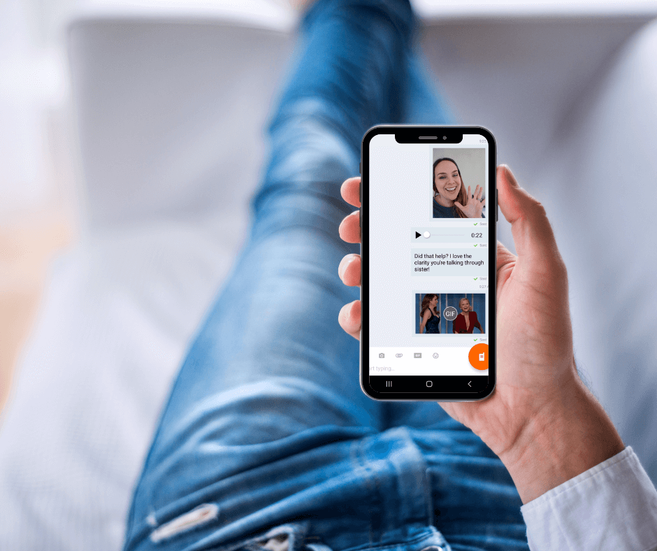 Woman entrepreneur holding a phone showing an asynchronous voice message conversation — what it looks like to work with a women entrepreneur coach Cara Chace via Voxer or WhatsApp.