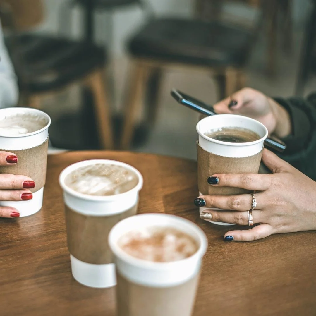 women having coffee and chatting for chaos and coffee meetup