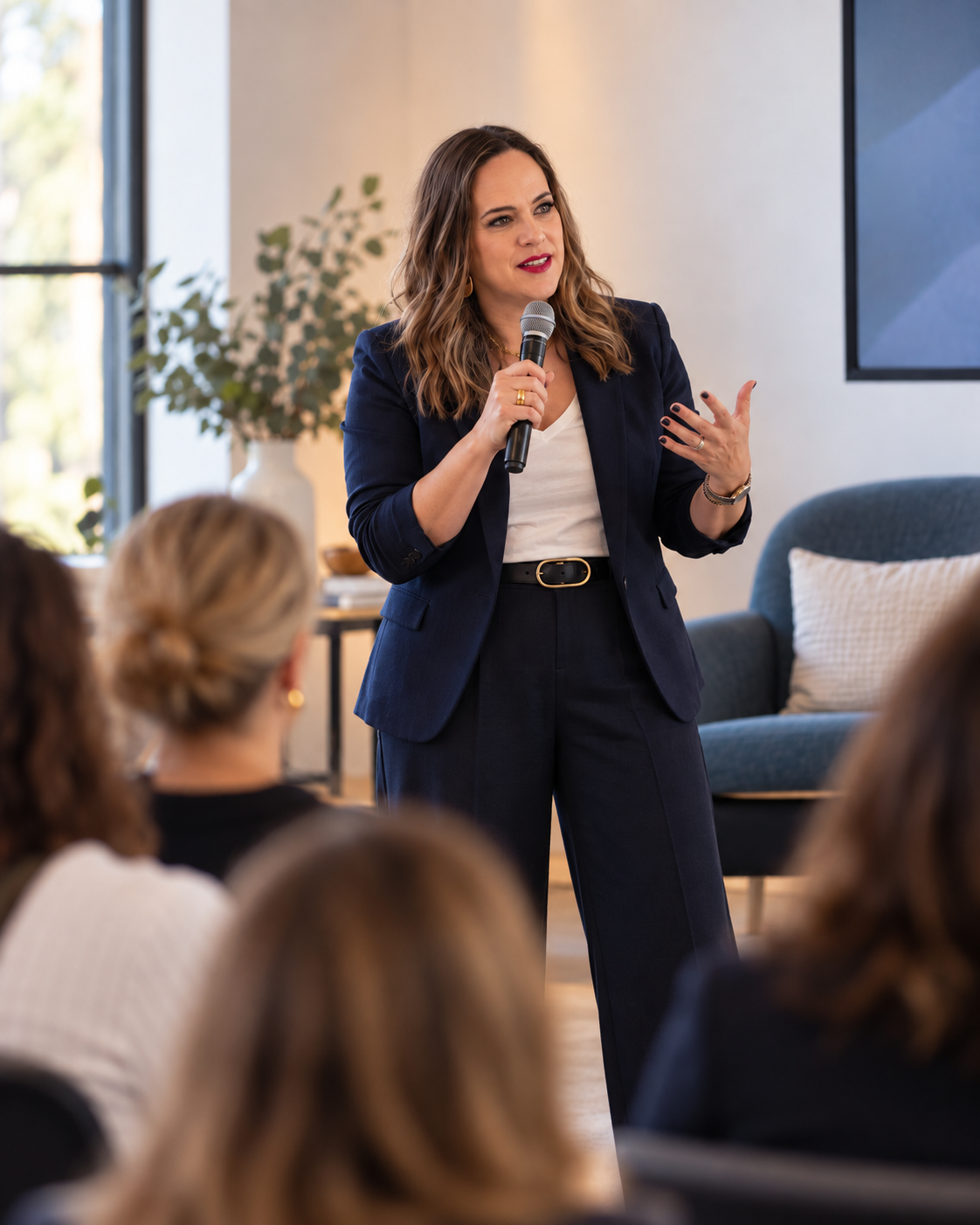 Cara Chace, author and speaker, talking with a microphone to a room of women in business