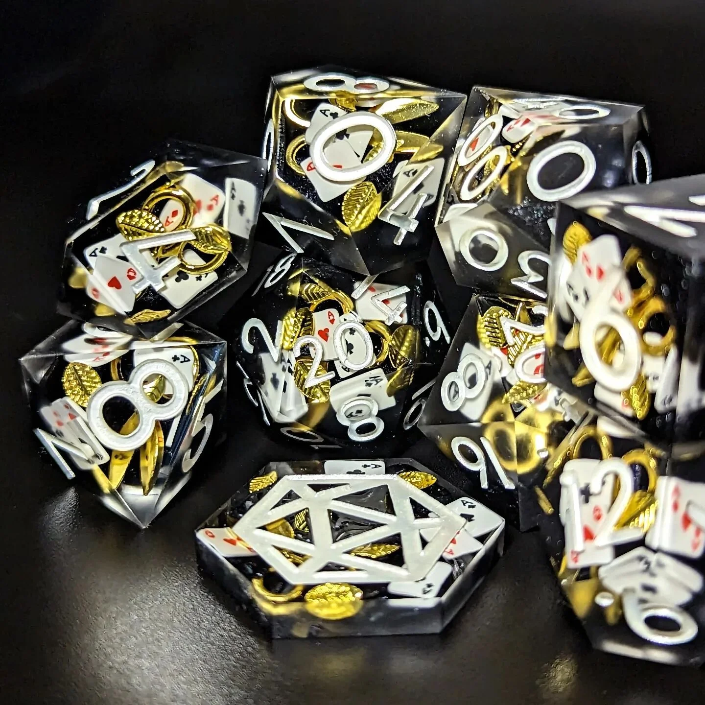 Golden shears, golden leaves, and polyclay playing cards make up the inclusions of this mysterious commission set we made for the wonderful @whiteleyfoster! Give them a follow for some amazing art and gorgeous character design. 🖤