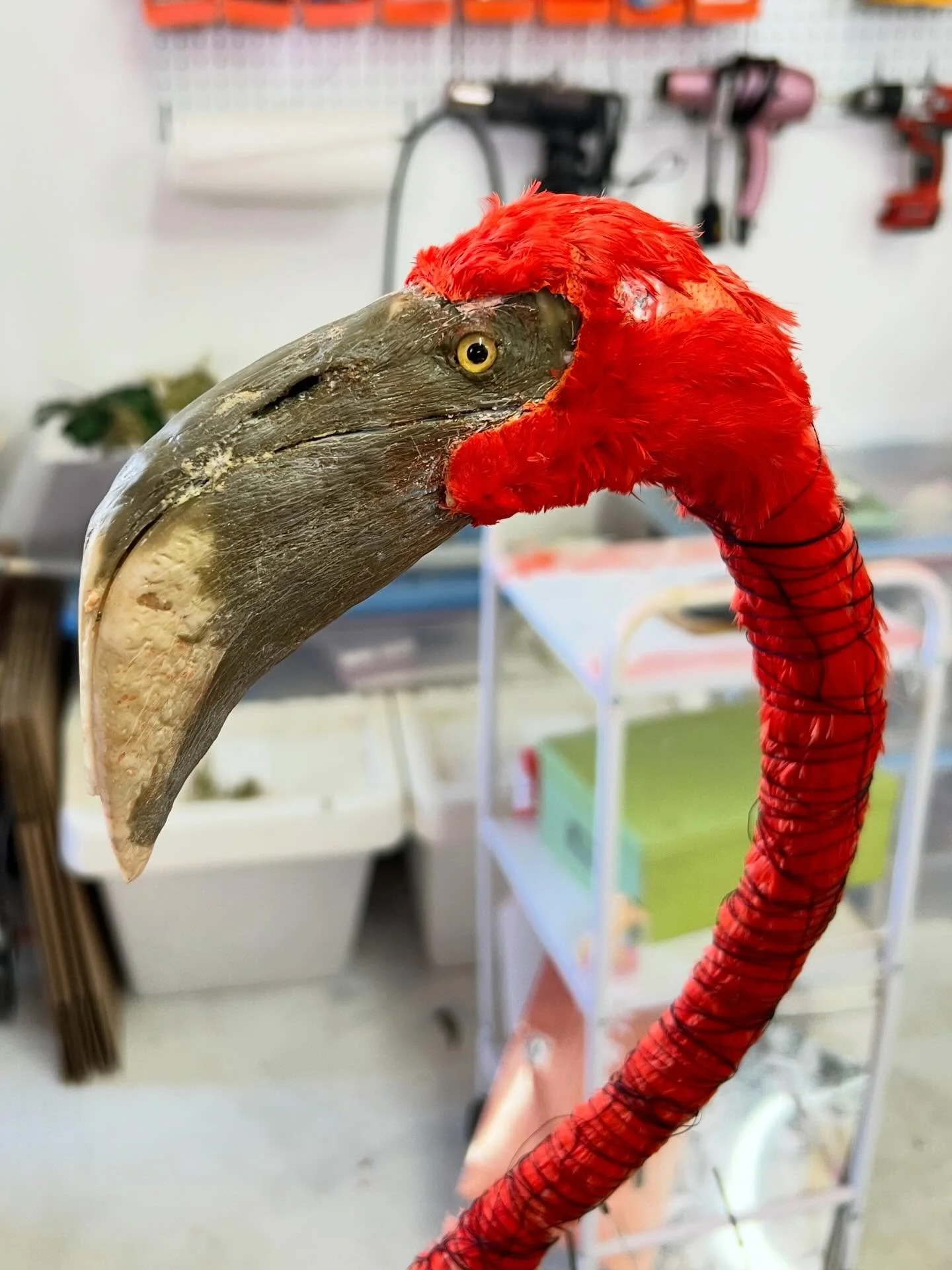 Replica flamingo face in progress! Flocking and feathers are placed individually to recreate the face. Still more feathers to add and smooth out, but you can see how she&rsquo;s coming along 🦩