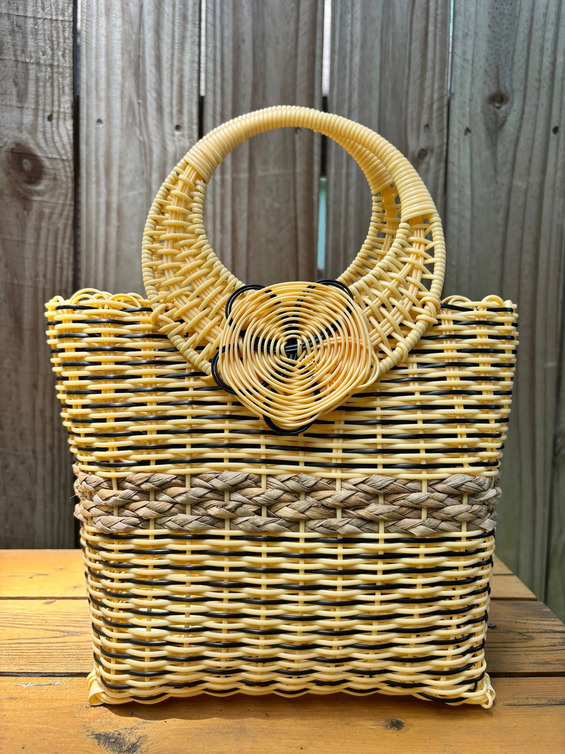 Handwoven yellow handbag with rose look.
