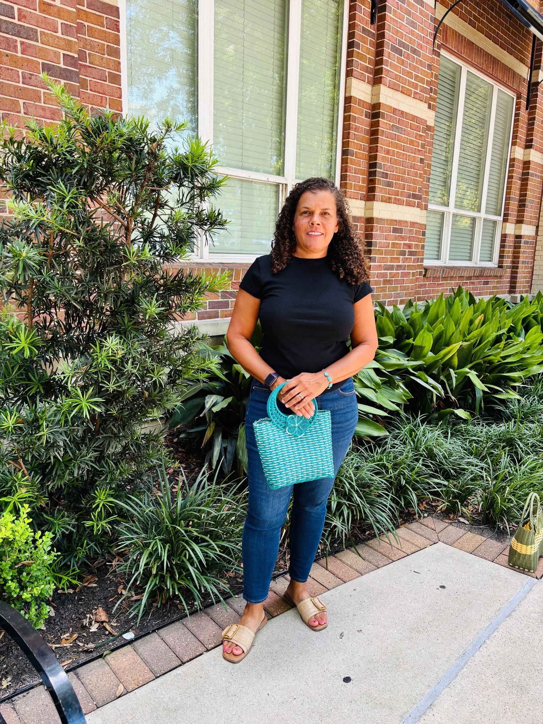 Lady holding a teal handbag