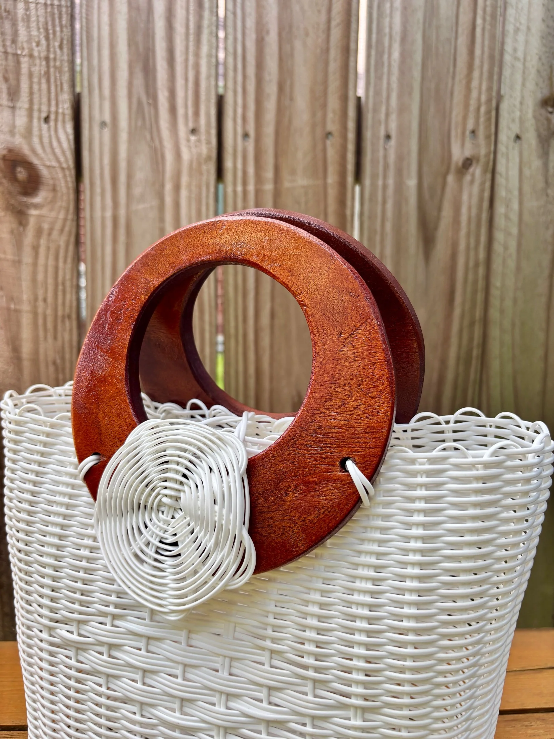 Wood handled white bag made from up cycled materials.