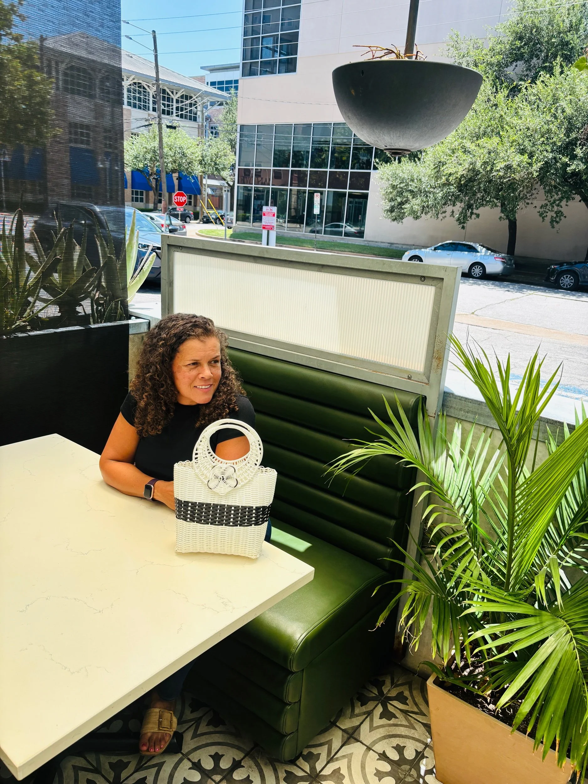 Lady at a restaurant with a handbag.