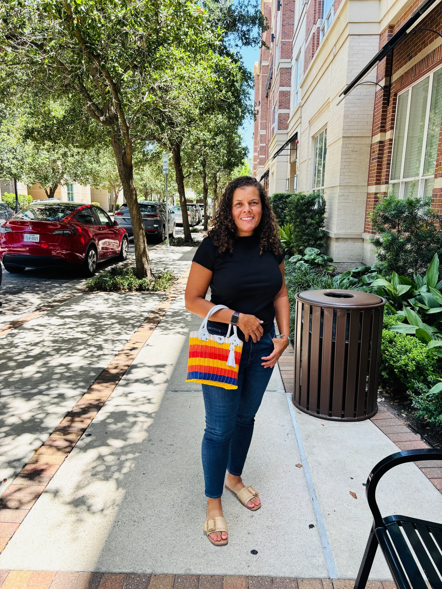 women holding Astros color handbag