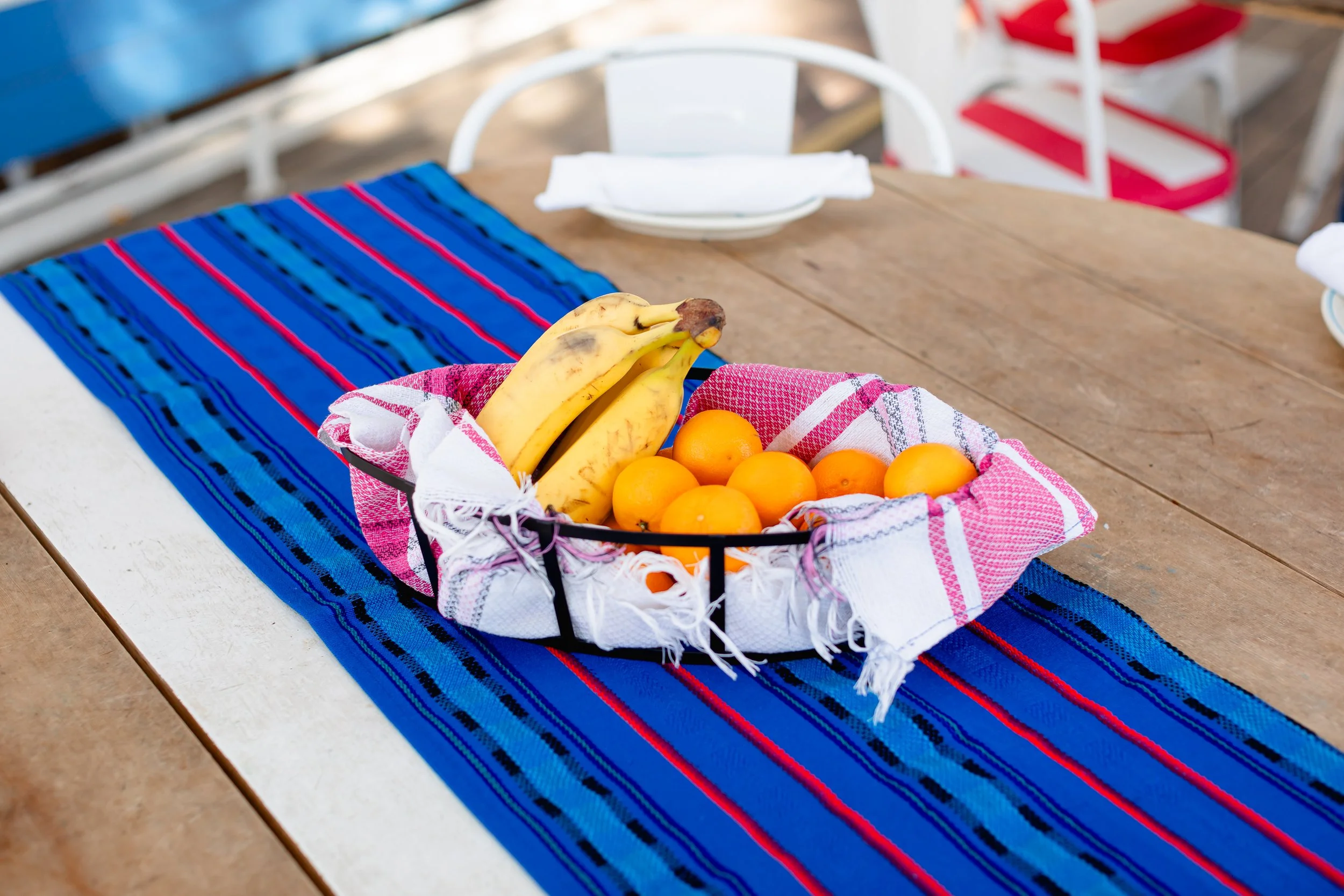 Blue runner handwoven in El Salvador on an outside table.