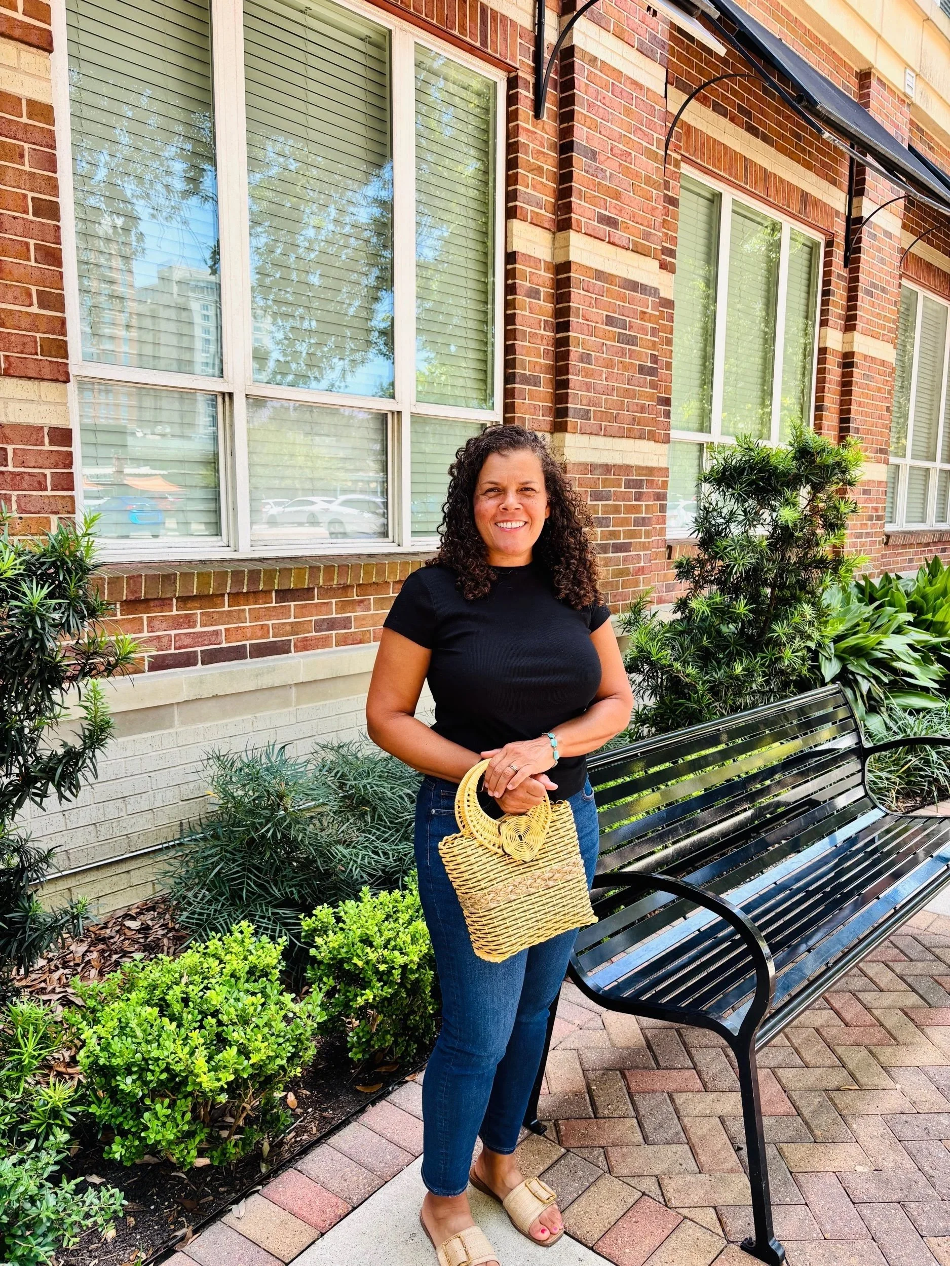 Lady holding a yellow bag downtown.