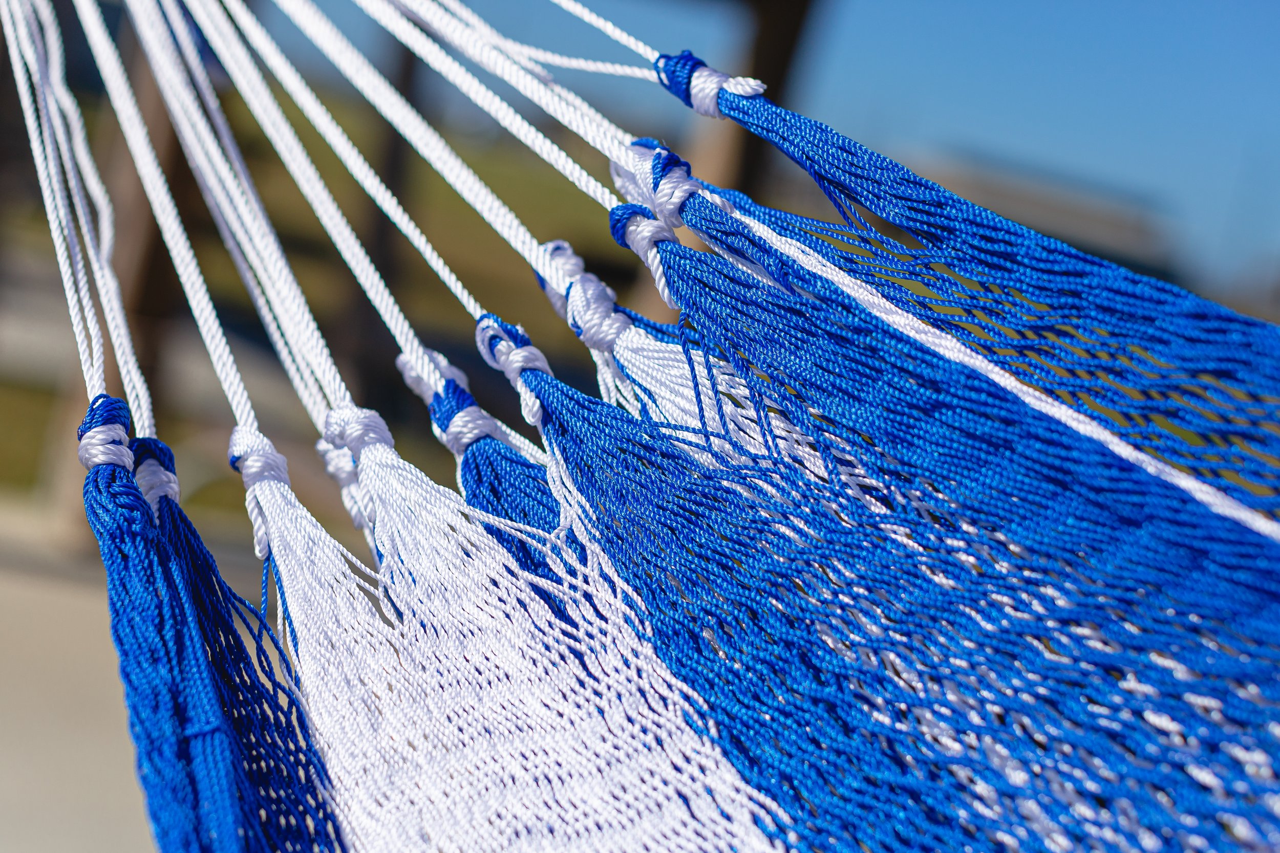 Close-up of the woven texture of the handcrafted blue and white hammock made from nylon silk fibers.