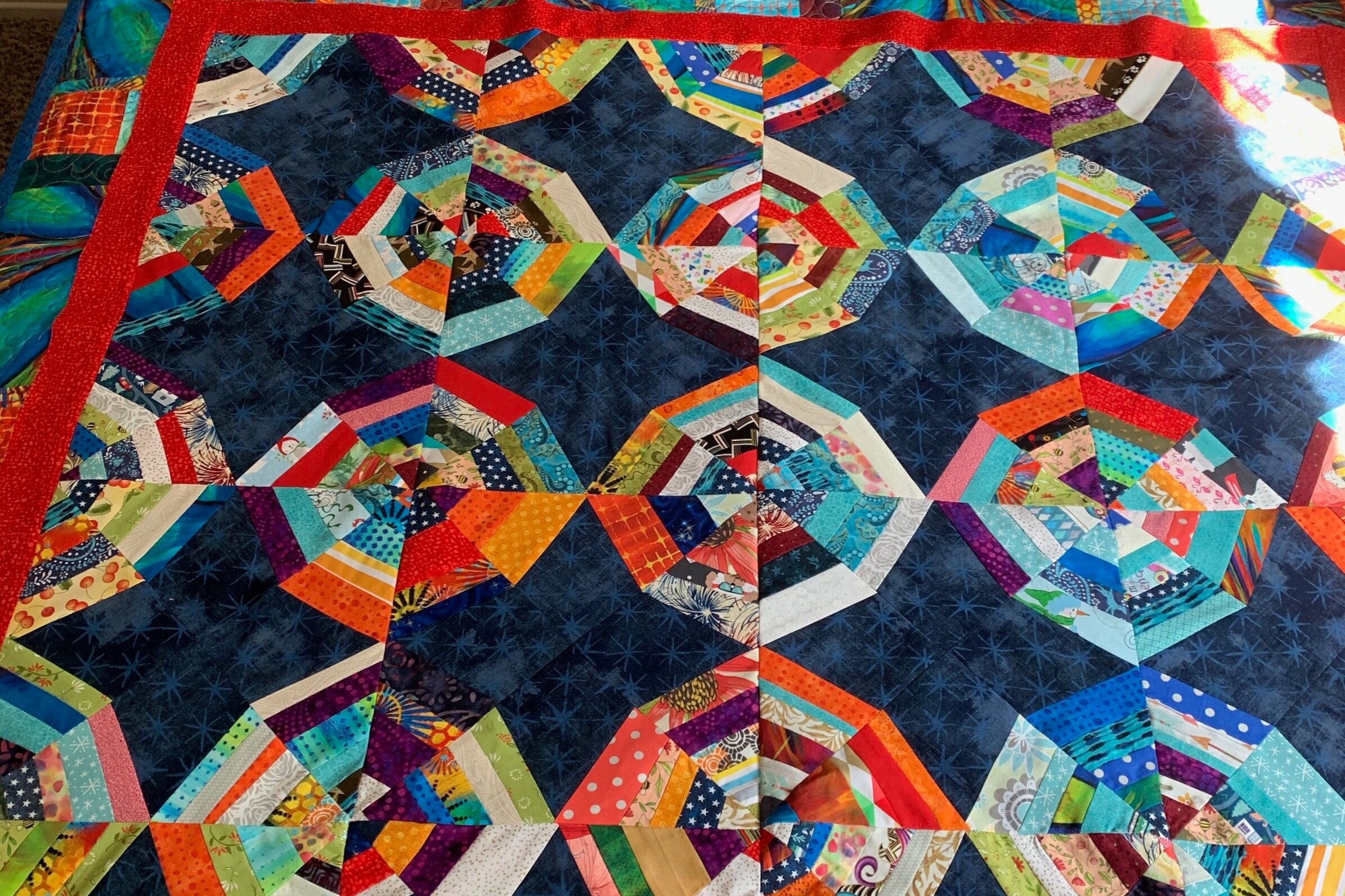 Scrappy Spider Web was backed in Denim for a picnic quilt
