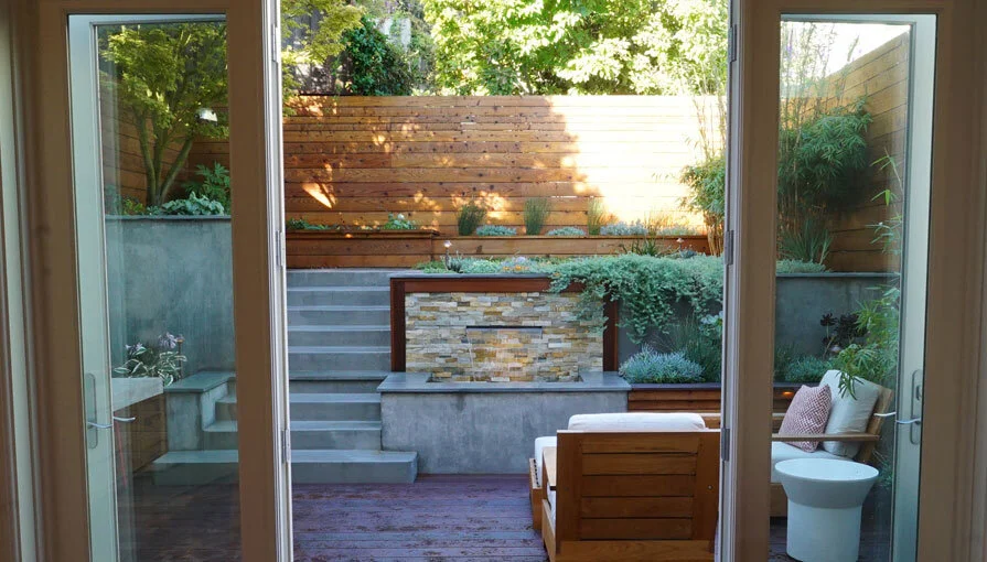 A San Francisco residential landscape design remodel with modern flair, expert craftsmanship, beautiful planting, amenities, irrigation, site lighting, retaining walls, wood deck, hot tub, spa, patio, BBQ, fire feature, bench, and paving.