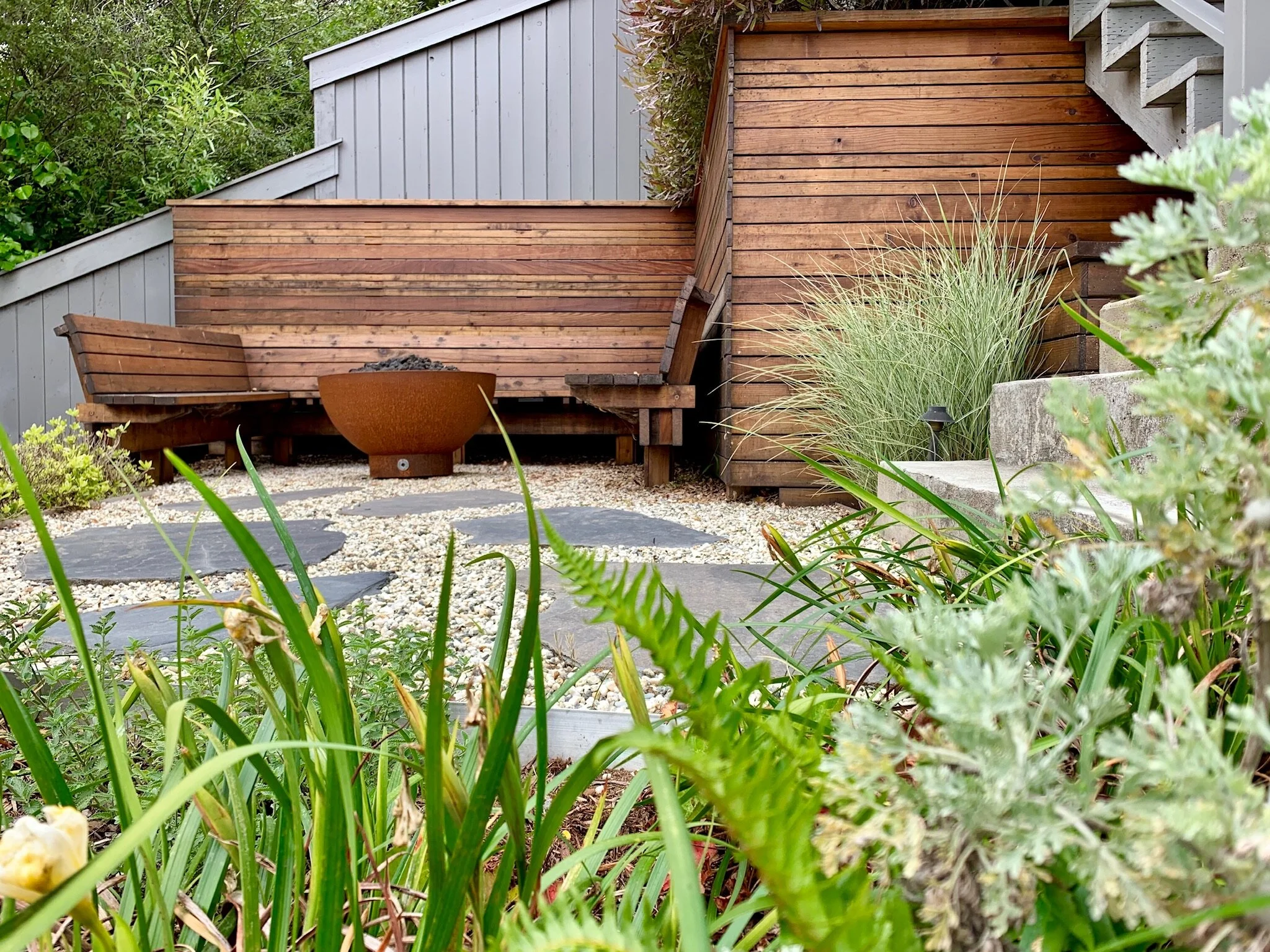 A San Francisco residential landscape design remodel with modern flair, expert craftsmanship, beautiful planting, amenities, irrigation, site lighting, retaining walls, wood deck, hot tub, spa, patio, BBQ, fire feature, bench, and paving.