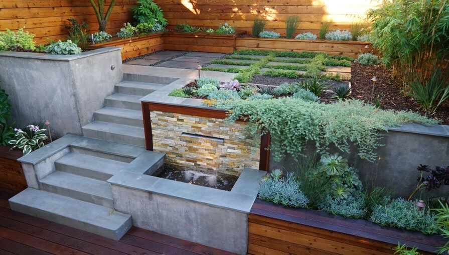 A San Francisco residential landscape design remodel with modern flair, expert craftsmanship, beautiful planting, amenities, irrigation, site lighting, retaining walls, wood deck, hot tub, spa, patio, BBQ, fire feature, bench, and paving.