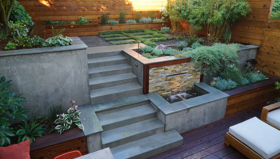 A San Francisco residential landscape design remodel with modern flair, expert craftsmanship, beautiful planting, amenities, irrigation, site lighting, retaining walls, wood deck, hot tub, spa, patio, BBQ, fire feature, bench, and paving.