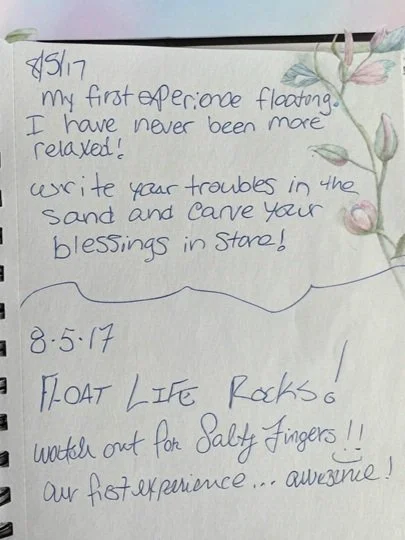 Handwritten note on decorated paper expressing a first floating experience and encouragement to enjoy salty finger snacks.