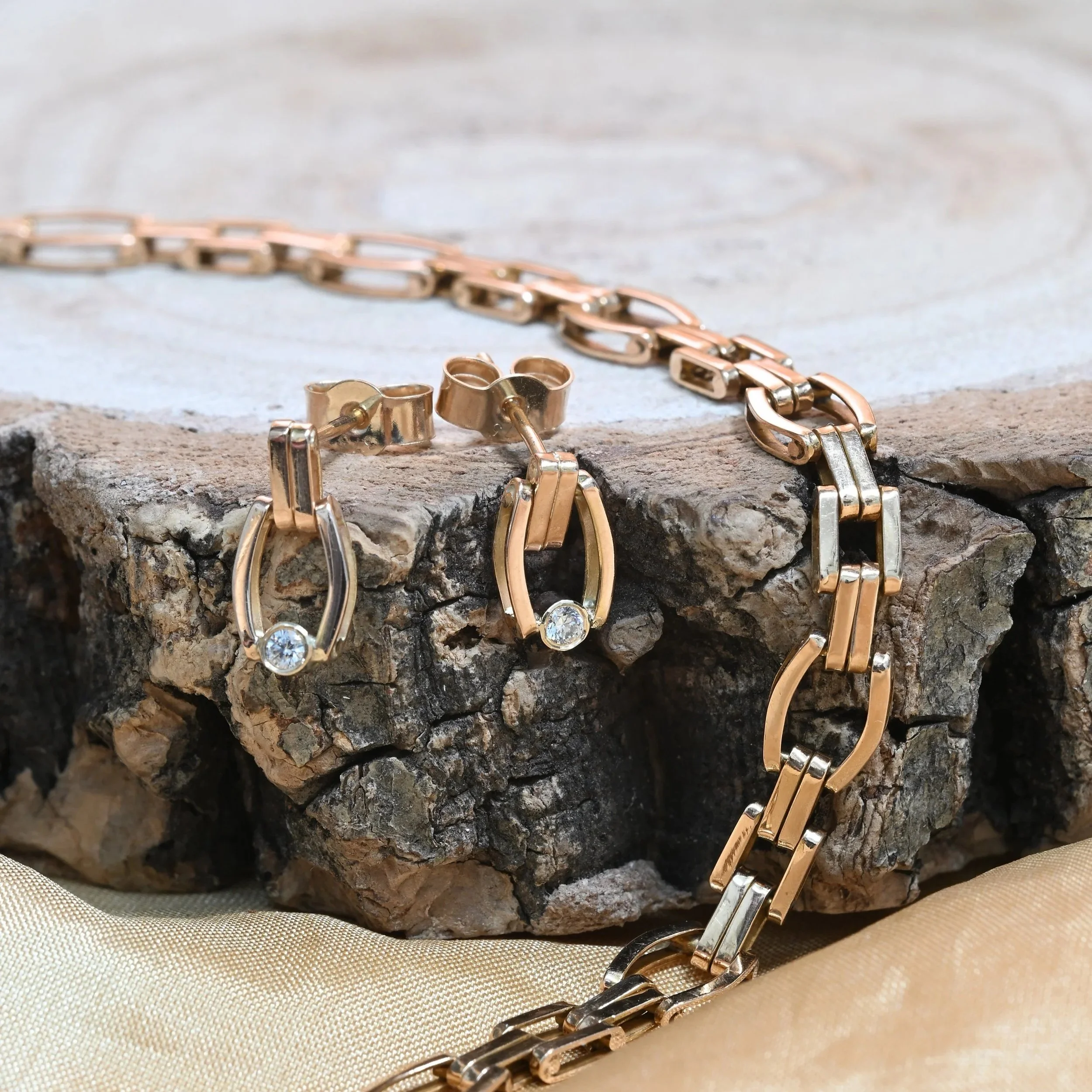 Bespoke diamond dangle earrings made using links from customers bracelet