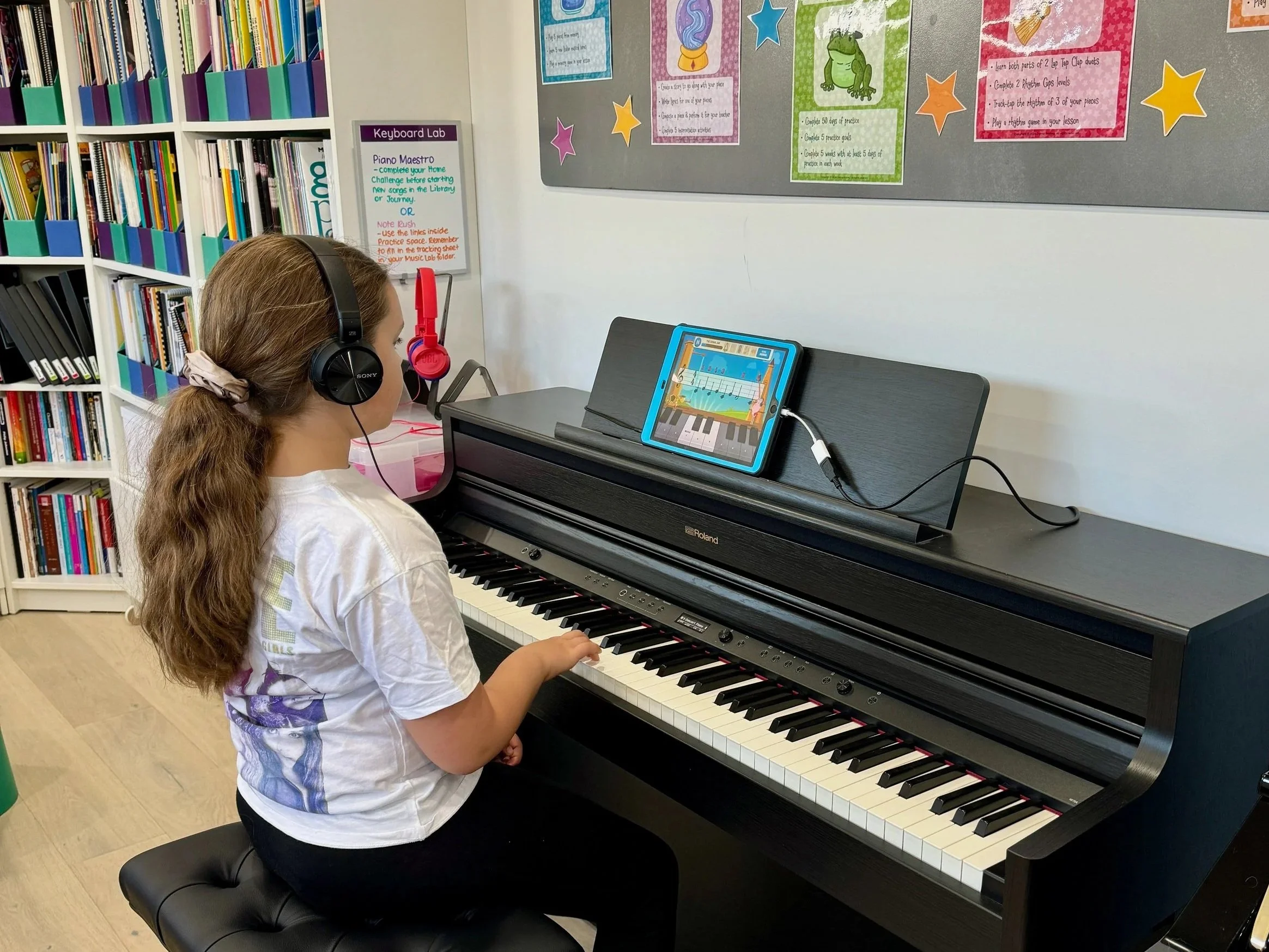 student using ipad at digital piano