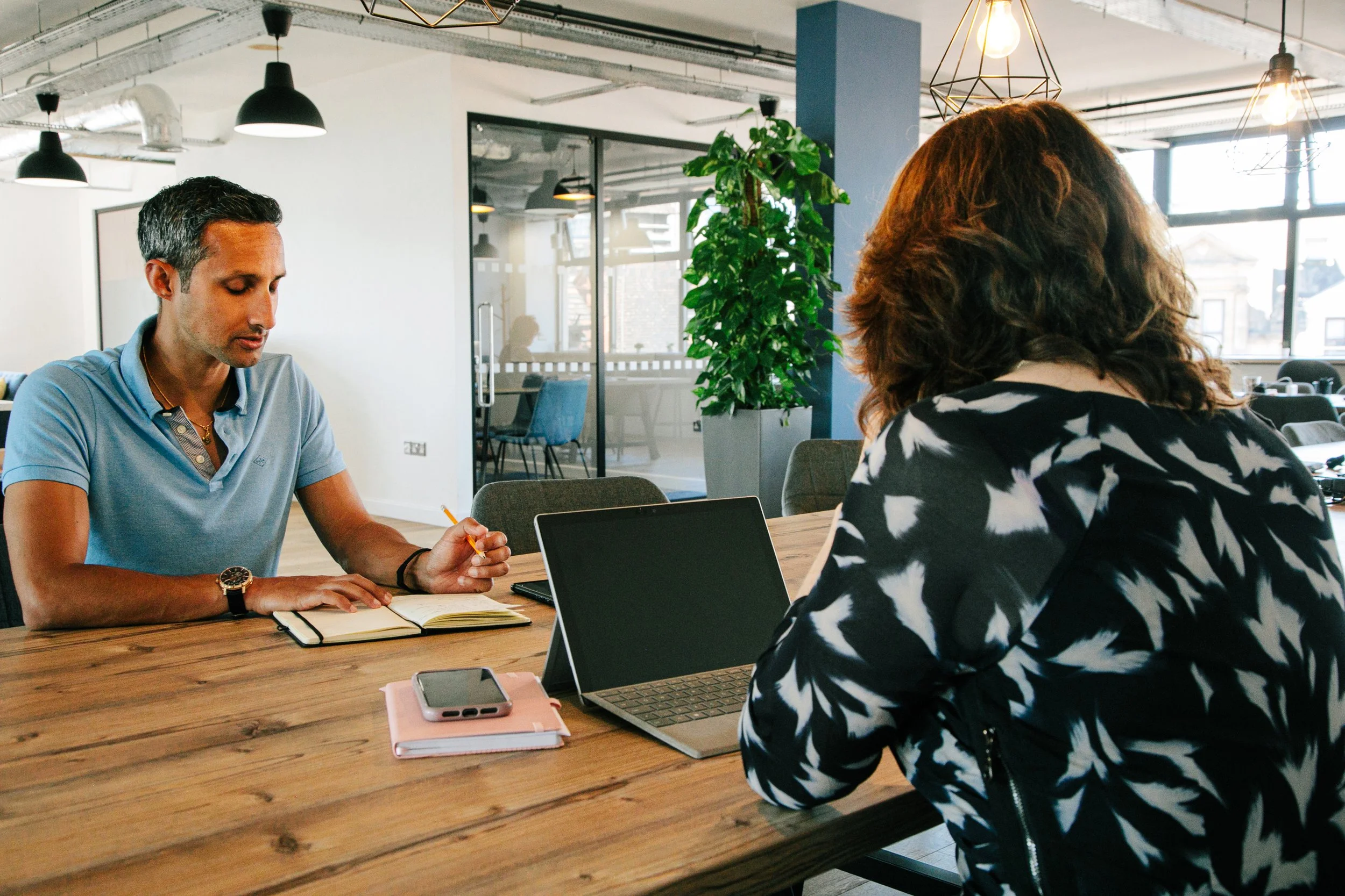 Image of principal consultant Hannah Welch  working with a client in a boardroom