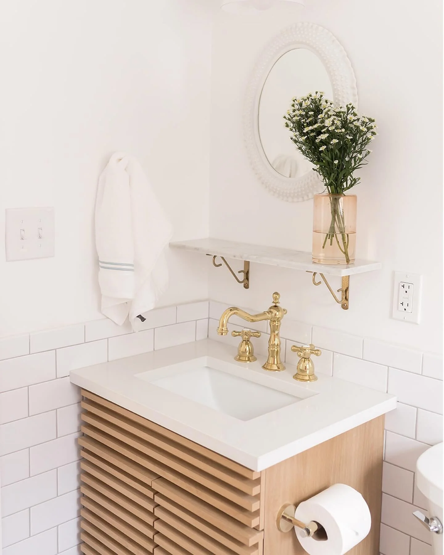 because the tile and tub serve as such bold design elements in this small bathroom space, we kept things simple with the vanity at the #mixedusemini. a minimal white oak vanity occupies the corner of the room and is topped with durable white quartz. 