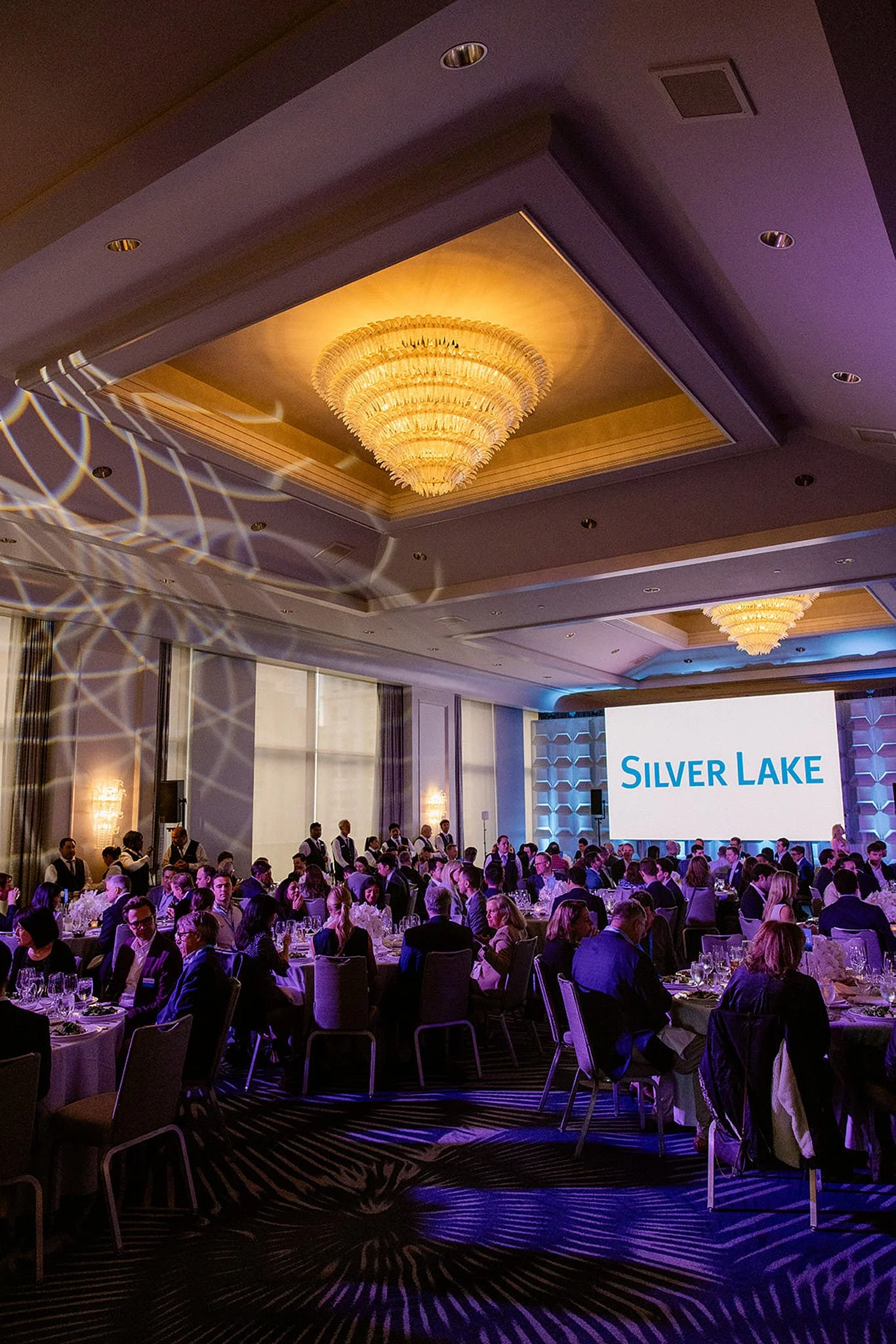 Wide view of a luxury corporate gala dinner for Silver Lake Partners in a San Francisco ballroom. Grand-scale event photography by Michaela Joy Photography.