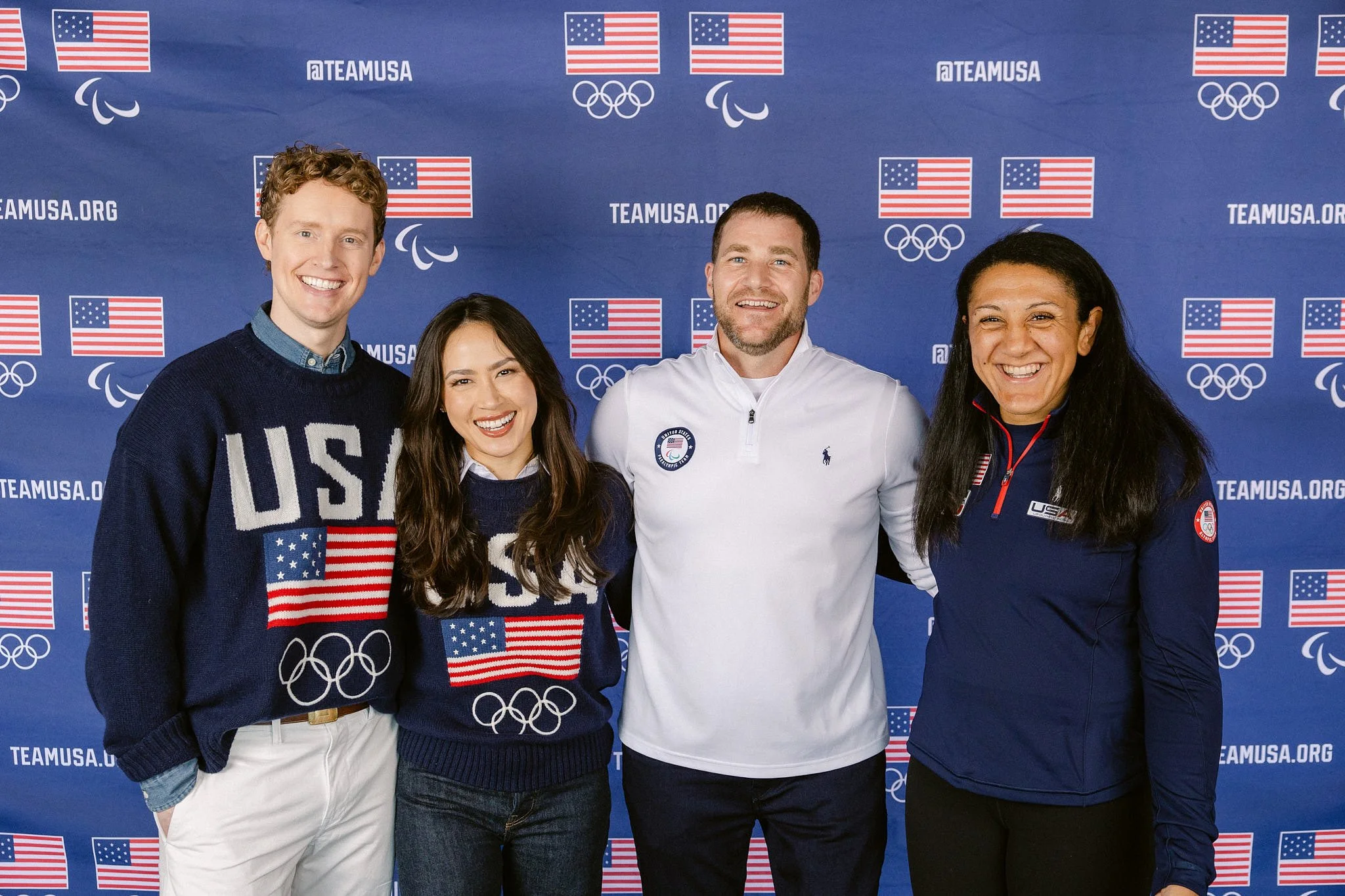 Portrait of USOPC leadership and Milano Cortina medalists in front of a Team USA branded backdrop. High-level corporate and Olympic event photography by Michaela Joy Photography.