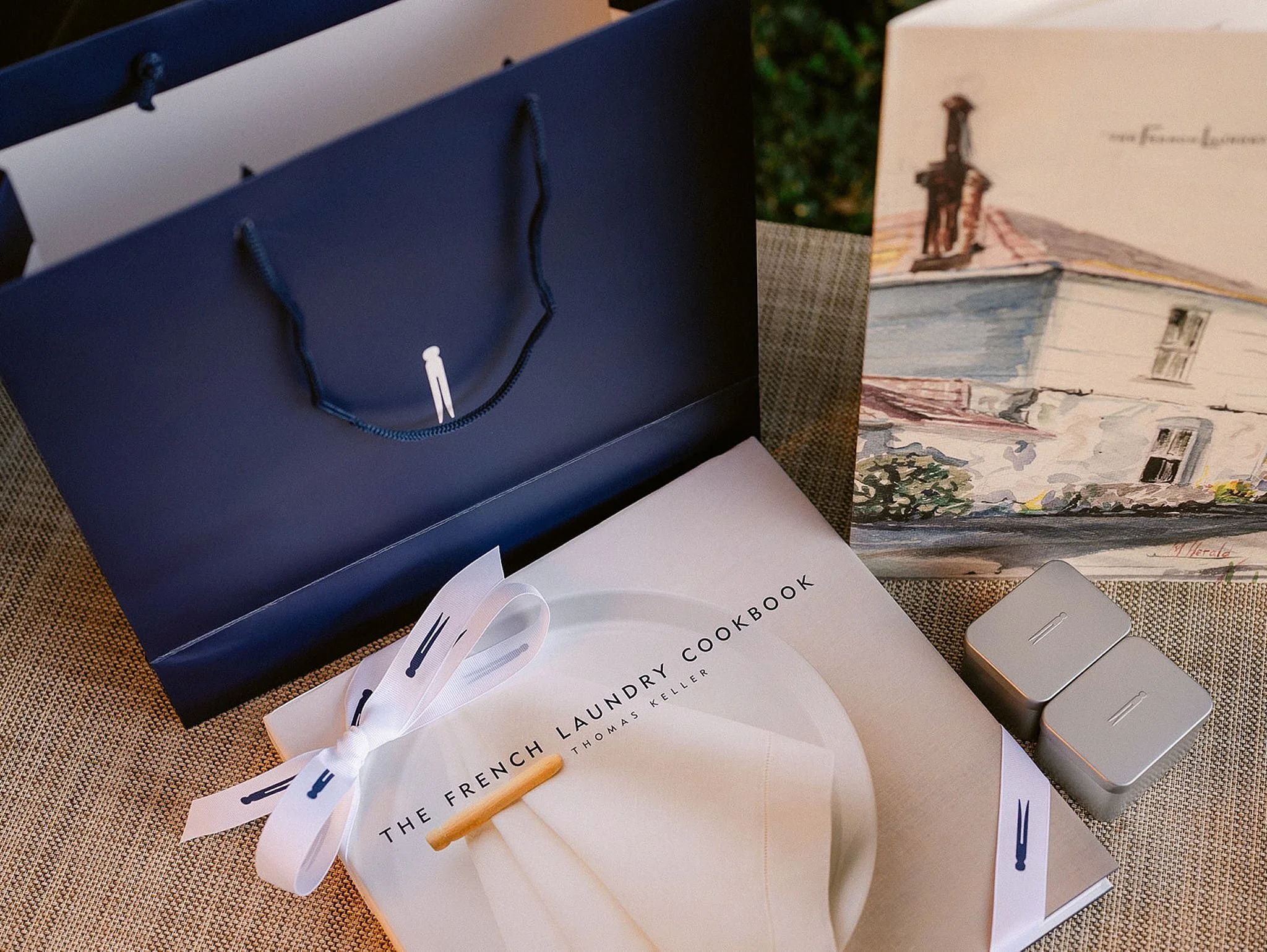 Luxury corporate gifting detail featuring The French Laundry cookbook and custom branded gift bags in Napa Valley. Retreat branding photography by Michaela Joy Photography.